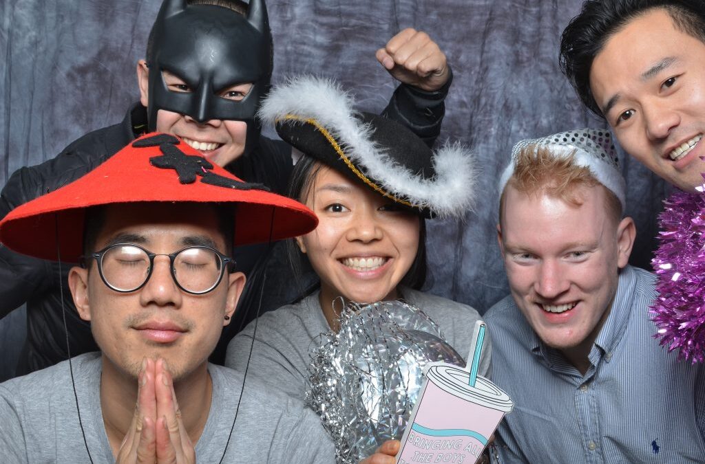 people posing and smiling for a memorable moment in photo booth